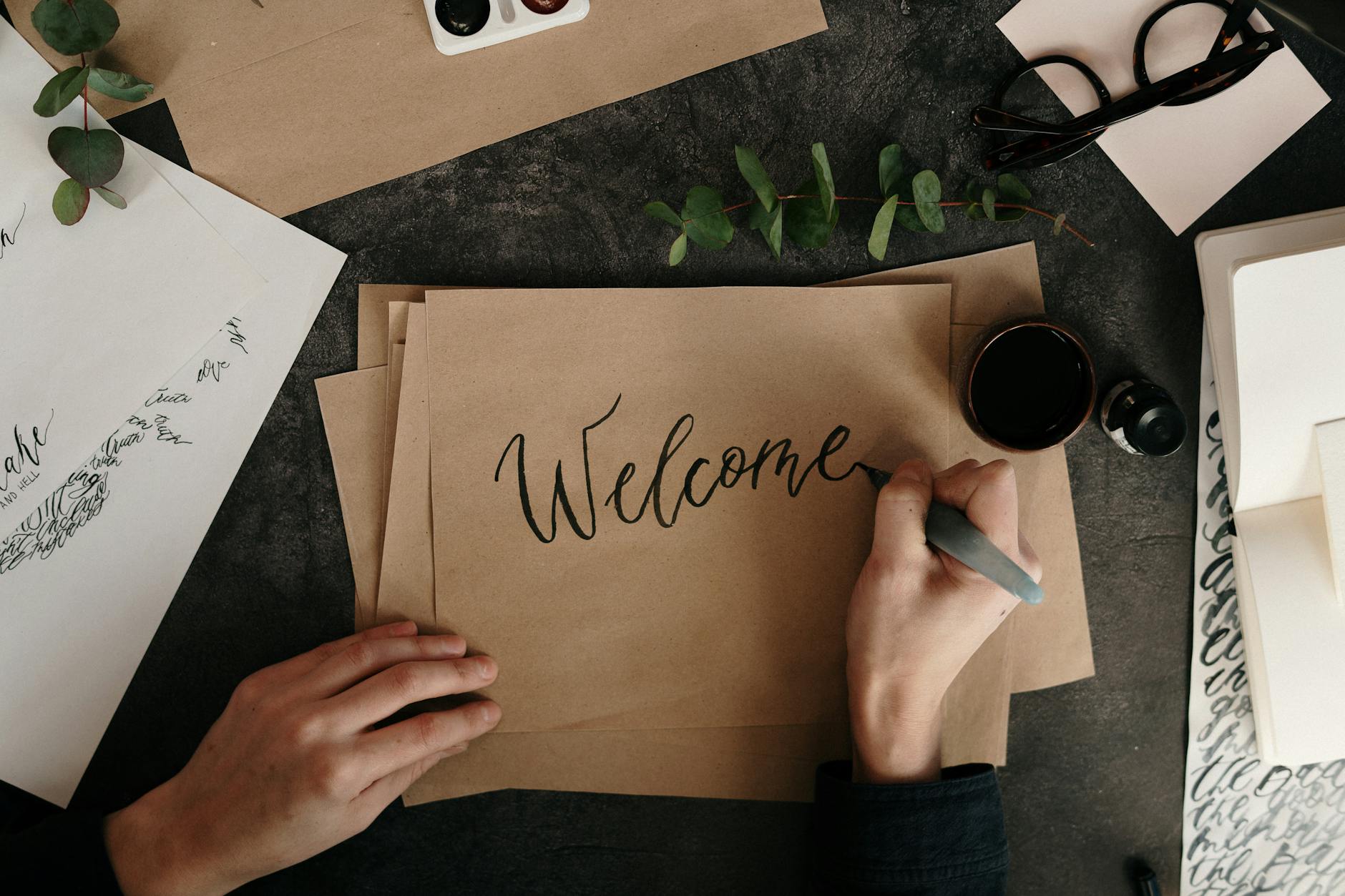 person writing on brown paper